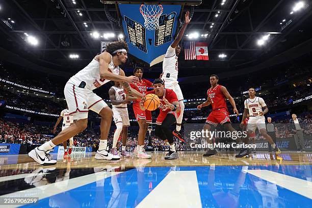 Houston Mallette of the Alabama Crimson Tide and LeJuan Watts of the Texas Tech Red Raiders reach for a loose ball during the first half in the...