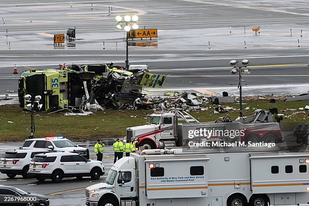 An a Port Authority fire truck sits on the runway after colliding with an Air Canada Express CRJ-900 at LaGuardia Airport on March 23, 2026 in New...