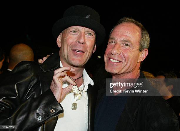 Actor Bruce Willis and executive producer Arnold Rifkin pose at the premiere of "Tears of the Sun" at the Village Theater on March 3, 2003 in Los...