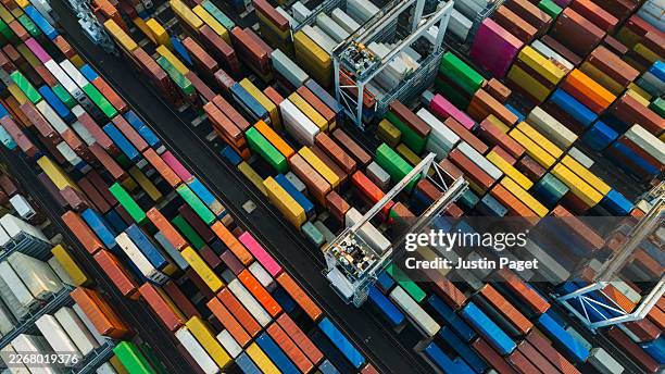 aerial/drone view of colourful containers in the port cargo area - drone delivery stock-fotos und bilder