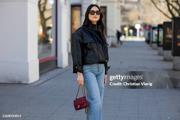 Aylin Sengül wears denim jeans &other stories, sunglasses Phoebe Philo, red bag Chanel on March 23, 2026 in Berlin, Germany.