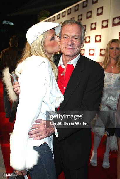 Socalite Paris Hilton greets playboy Hugh Hefner at the grand opening of the club/restaurant White Lotus on March 7, 2003 in Hollywood, California.