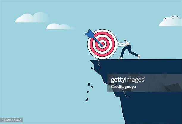 white collar workers push their targets off the cliff. losing confidence in the target. - reaching down stock illustrations