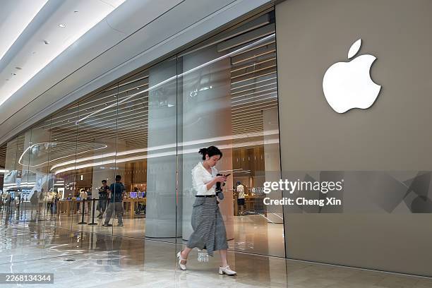 Pedestrian walks past an Apple Store in a shopping mall on March 24, 2026 in Shenzhen, Guangdong province, China. Apple continues to operate retail...