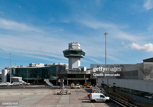 terminal 1 and the old air traffic control tower at manchester airport - england, uk - manchester airport stock pictures, royalty-free photos & images