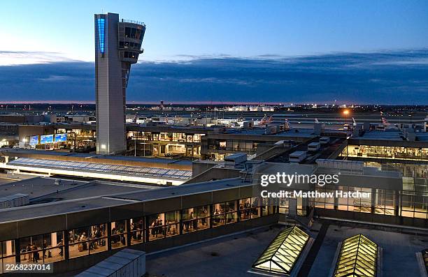 Travelers wait in a line that stretches to the parking garage at the Philadelphia International Airport on March 28, 2026 in Philadelphia,...