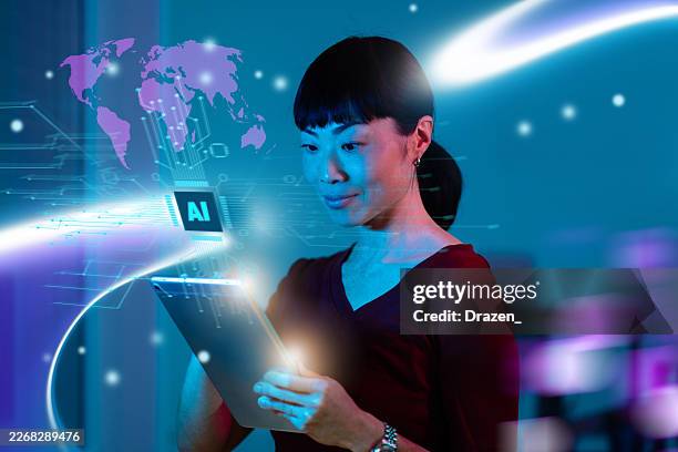 successful asian businesswoman using artificial intelligence on digital tablet - one world stock pictures, royalty-free photos & images