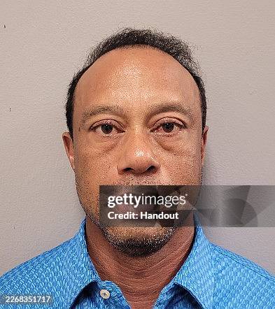In this handout photo provided by the Martin County Sheriff's Office, Tiger Woods poses for his booking photo after his arrest on March 27, 2026 in...