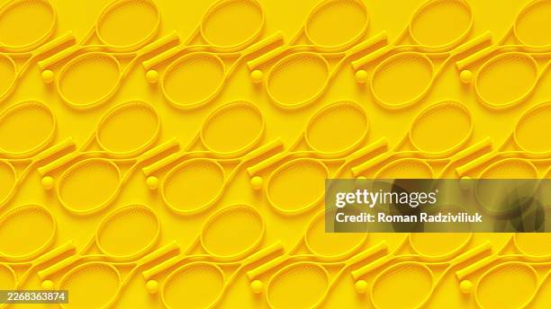 Flat lay monochrome yellow seamless pattern of tennis rackets and balls on a matching vibrant yellow background.