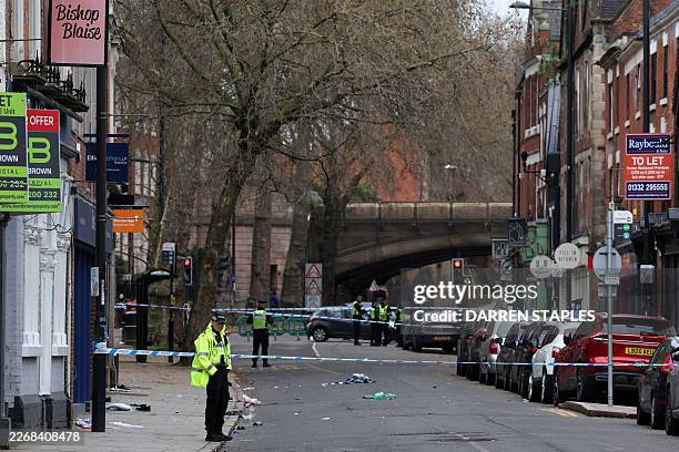 Police officers work near a cordon set up on Friar Gate in central Derby, central England on March 29 following an incident the night before where a...