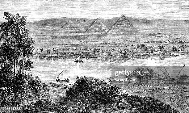ilustrações de stock, clip art, desenhos animados e ícones de pyramids of giza rising beyond the nile from the eastern bank, small sailboats drift on calm water while two men stand in the foreground, quietly observing a vast and timeless landscape - rio nilo