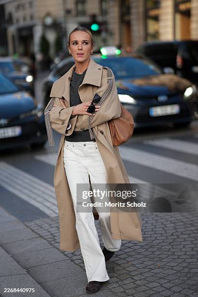 Josefien L. G. Weyns is seen wearing a beige oversized "Drop Waist Trenchcoat" with a double breasted closure featuring a storm flap and brown and...