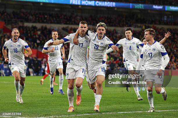 Edin Dzeko of Bosnia and Herzegovina celebrates scoring his team's first goal with teammates during the FIFA World Cup 2026 European Qualifiers KO...