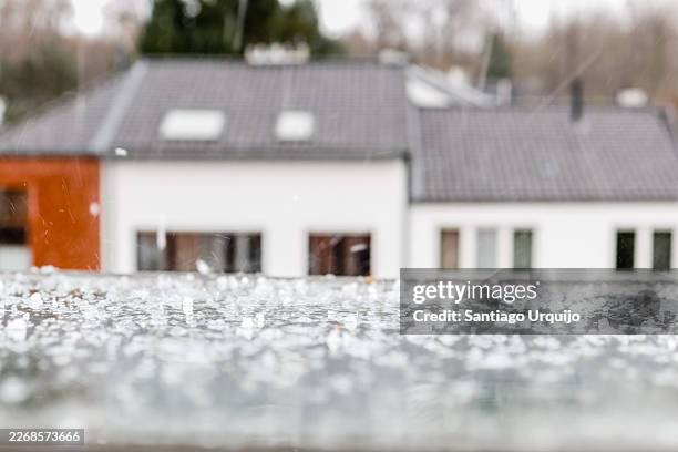 rain and hail dropping on an attic window - hail stock pictures, royalty-free photos & images