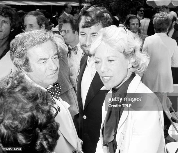 American singer and actress Dinah Shore talks to an unidentified man and woman during the 1st Daytime Emmy Awards at Rockefeller Plaza in New York,...