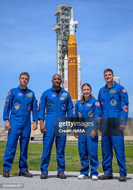 In this handout provided by NASA, NASA astronauts Reid Wiseman, Artemis II commander, left, Victor Glover, Artemis II pilot, Christina Koch, Artemis...