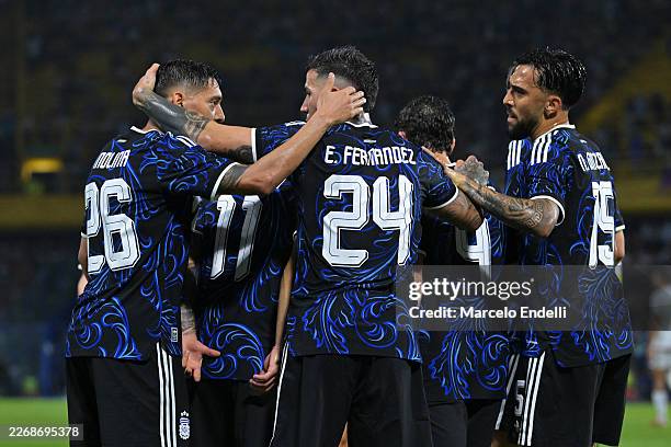 Enzo Fernandez of Argentina celebrates scoring his team's first goal with teammates Nahuel Molina and Nicolas Gonzalez during the international...