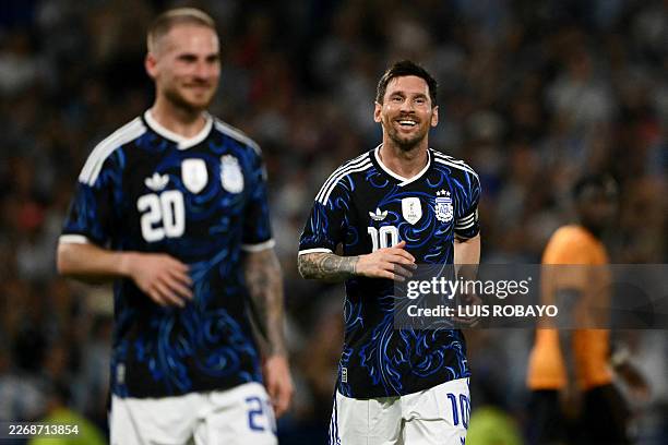 Argentina's forward Lionel Messi celebrates after his team's third goal scored by defender Nicolas Otamendi during a friendly football match between...