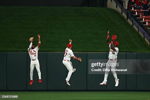 Victor Scott II, Nathan Church and Jordan Walker of the St. Louis Cardinals celebrate after beating the New York Mets at Busch Stadium on March 31,...