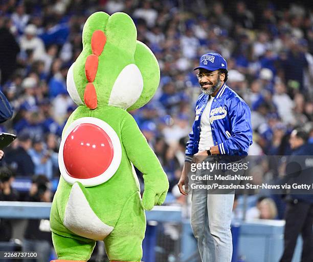 Los Angeles, CA Actor Donald Glover with Yoshi the Dino prior to a baseball game between the Los Angeles Dodgers and th Cleveland Guardians at Dodger...