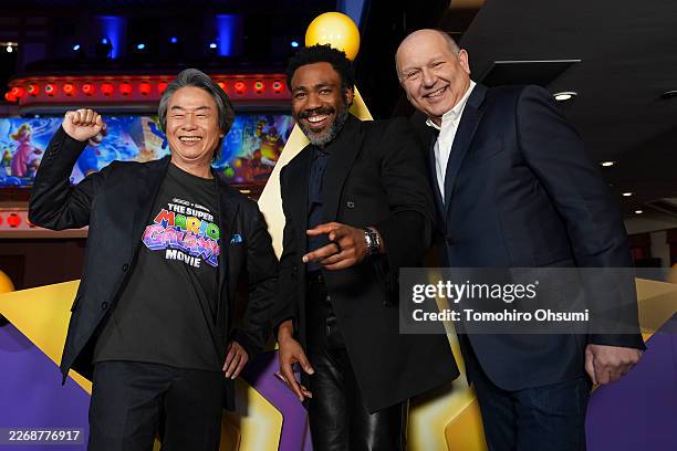 Shigeru Miyamoto, Donald Glover and Chris Meledandri pose for a photo as Universal Pictures, Nintendo and Illumination present the premiere of "The...