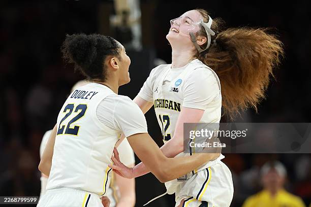Kendall Dudley and Syla Swords of the Michigan Wolverines react during the third quarter against the Louisville Cardinals in the Sweet Sixteen of the...
