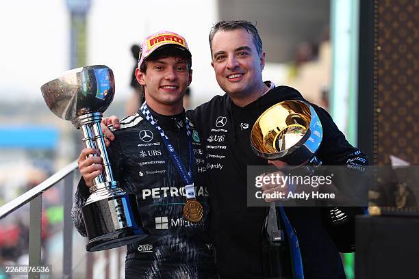 Race winner Andrea Kimi Antonelli of Italy and Mercedes AMG Petronas F1 Team celebrates on the podium with his teammate during the F1 Grand Prix of...