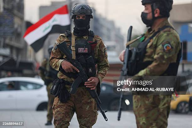 Members of Iraq's Hashed al-Shaabi forces stand guard during a pro-Iran rally in Tahrir Square in Baghdad on April 2, 2026. The US embassy in Baghdad...