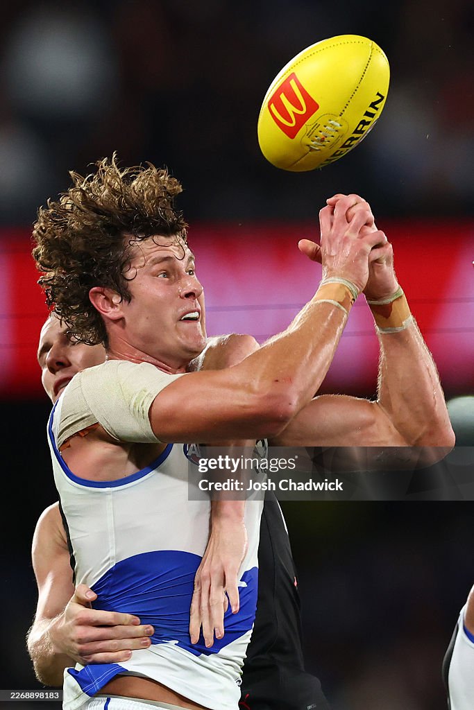 Comben Charlie Comben of the Kangaroos attempts to mark in front of Lachlan ...