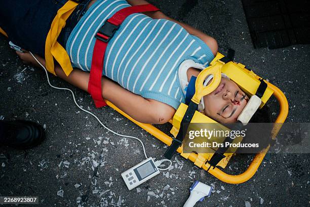 paramedics checking the oxygen saturation of a car accident victim. - accident victim stock pictures, royalty-free photos & images