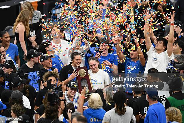 The UCLA Bruins celebrate with the trophy after defeating the Notre Dame Fighting Irish 70-52 in the Elite Eight of the 2026 NCAA Women's Basketball...