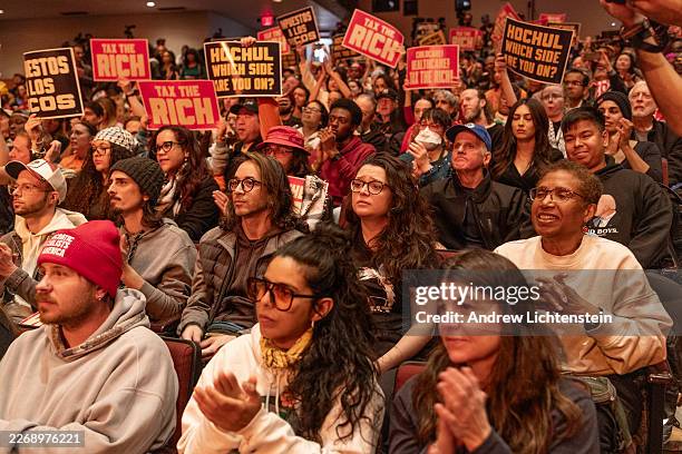 People attend a Tax The Rich political rally hosted by the Democratic Socialists of America and featuring Senator Bernie Sanders, March 29 at Lehman...