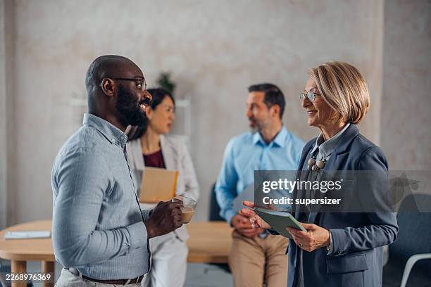 cheerful interaction in contemporary workspace - emotional intelligence stock pictures, royalty-free photos & images