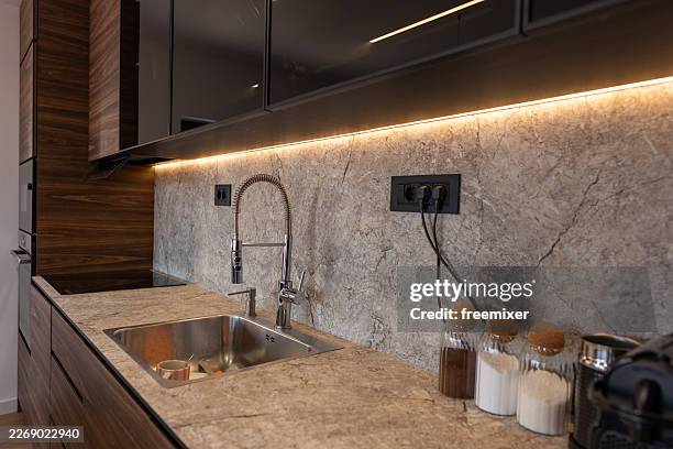 modern kitchen interior with stainless steel sink, pull-down faucet and stone countertop - back lit stock pictures, royalty-free photos & images