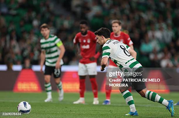 Sporting Lisbon's Portuguese forward Pedro Goncalves scores the equalising goal from the penalty spot during the Portuguese League football match...