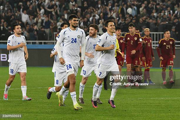 Muhammadrasul Abdumajidov and Otabek Shukurov of Uzbekistan celebrate after the penalty shoot out in the international friendly match between...