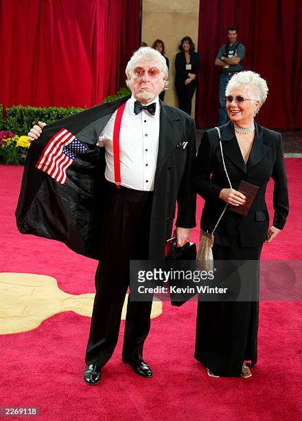 Comedian Marty Ingels shows off his American flag suit, as his wife, actress Shirley Jones, wearing Harry Winston jewelry, Steven Vaughn sunglasses...