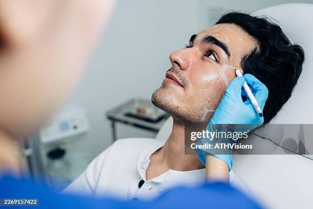 man undergoing non surgical facial contouring consultation - face lift stock pictures, royalty-free photos & images
