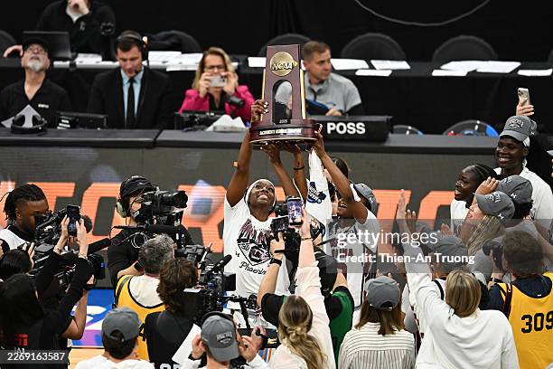 The South Carolina Gamecocks celebrate with the trophy after defeating the TCU Horned Frogs 78-52 in the Elite Eight of the 2026 NCAA Women's...