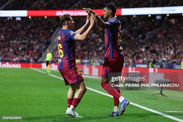 Barcelona's English forward Marcus Rashford celebrates scoring his team's first goal with Barcelona's Spanish midfielder Fermin Lopez during the...