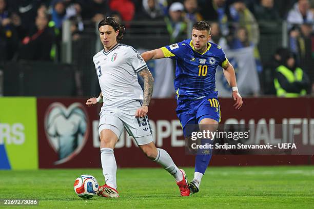 Riccardo Calafiori of Italy is challenged by Ermedin Demirovic of Bosnia and Herzegovina during the FIFA World Cup 2026 European Qualifiers KO...