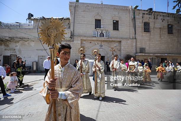 Orthodox Christians living in Gaza City, Palestine, attend a Mass at the Saint Porphyrius Church to celebrate 'Palm Sunday,' which commemorates Jesus...
