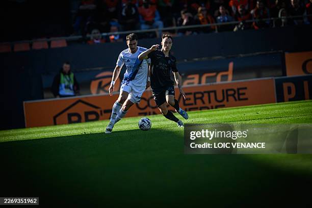 Lorient's French forward Pablo Pagis fights for the ball with Paris FC's defender Diego Coppola during the French L1 football match between FC...