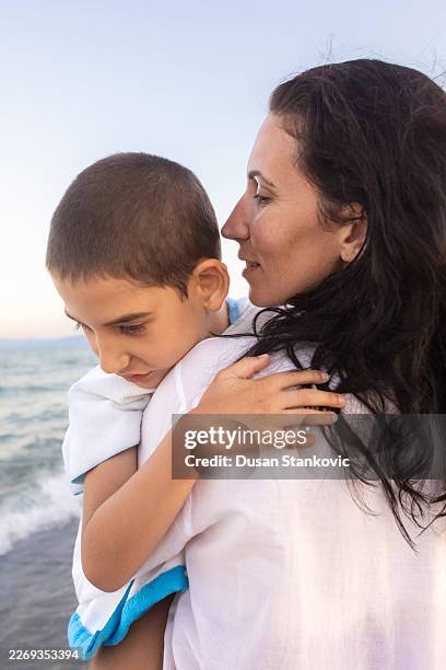 mother and son at the beach - developmental disability stock pictures, royalty-free photos & images