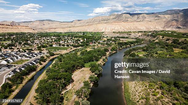 aerial view over river and irrigation canal and small town in desert - grand junction colorado stock pictures, royalty-free photos & images