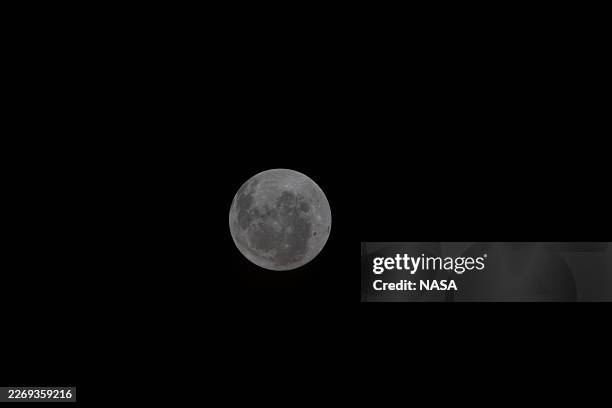 In this handout image provided by NASA, A view of the Moon taken by an Artemis II crewmember through the window of the Orion spacecraft on the third...