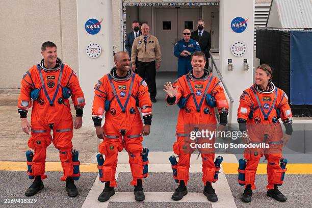 Mission specialist Jeremy Hansen of CSA , pilot Victor Glover, commander Reid Wiseman and mission specialist Christina Koch walk out of the Neil A....