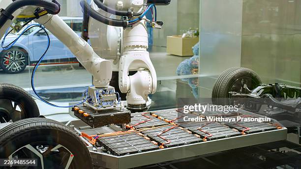 industrial robot arm assembling electric vehicle battery pack - battery pack stock pictures, royalty-free photos & images