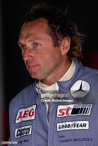 Jochen Mass from Germany, driver of the Team Sauber-Mercedes Mercedes-Benz C11 Mercedes-Benz M119 Turbo V8 looks on from the pit garage during the...