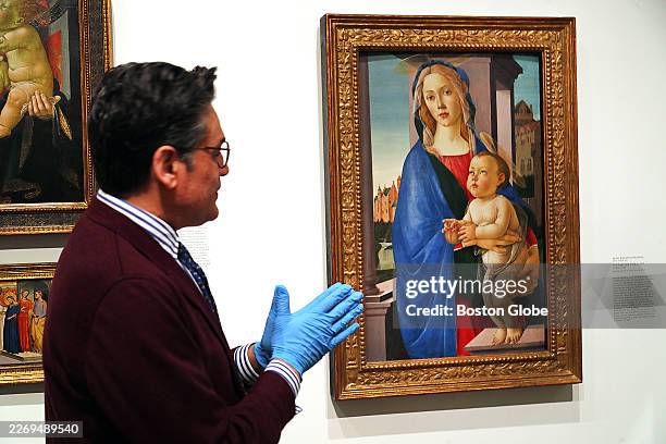 Cambridge, MA Narayan Khandekar, curator of the Forbes Pigment Collection, looks at The Virgin and Child, a painting by Sandro Botticelli, at Harvard...